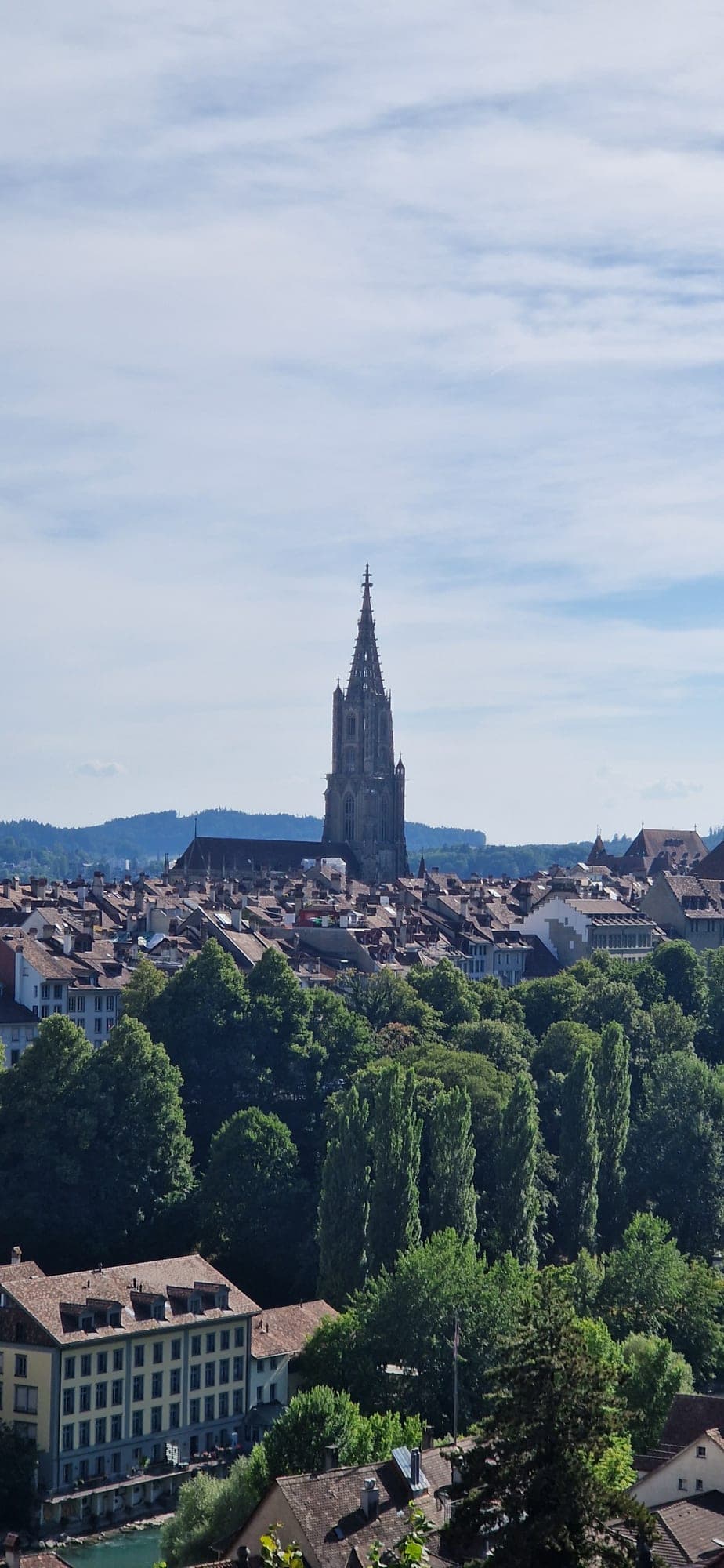 The spire of the Bern Minster rising over the old town rooftops